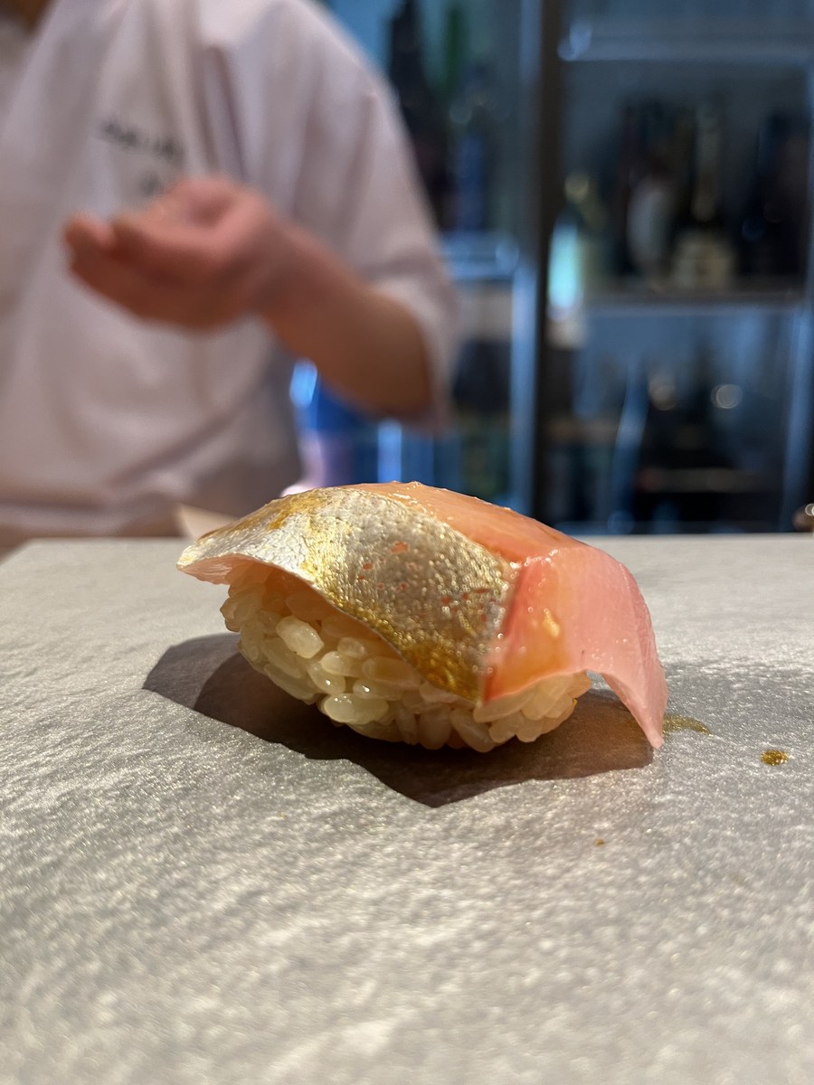 A piece of shimaaji (striped jack) nigiri at Akira