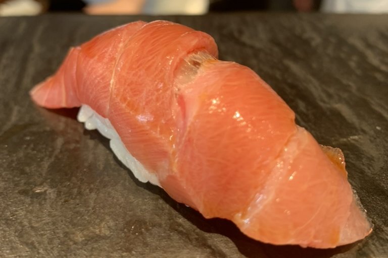 A jabara ōtoro nigiri, the tuna draped to show the accordion pattern of fat and sinew
