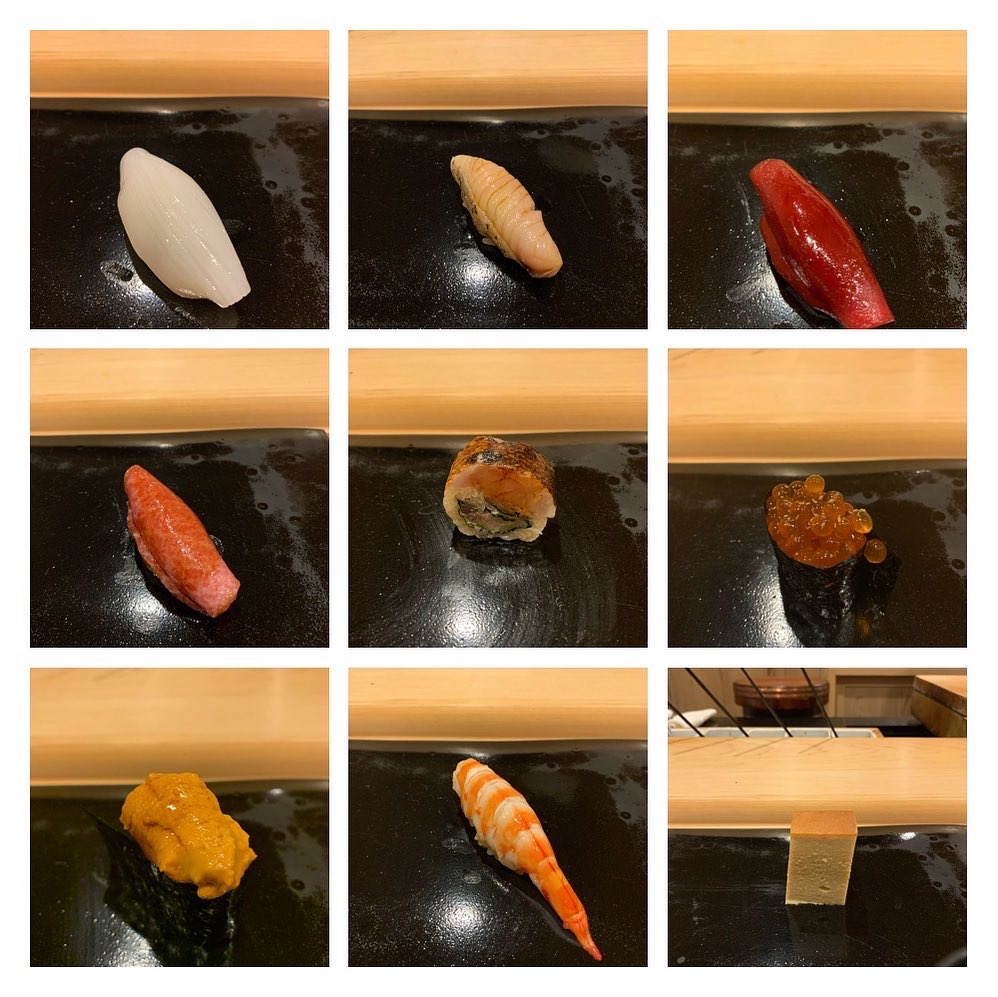 A grid of nigiri served in sequence — squid, white fish, akami and toro, anago, ikura, uni, ebi, and tamago to close