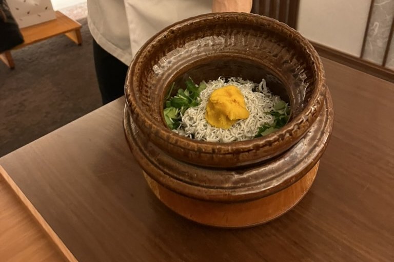 A clay pot of kamameshi with shirasu (Whitebait), presented at the table by the chef