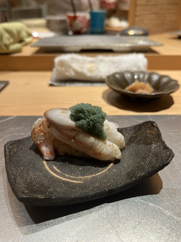 A lightly cooked botan-ebi nigiri topped with green roe