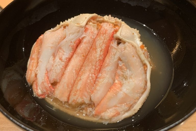 Snow crab picked and set back over its shell in a warm broth