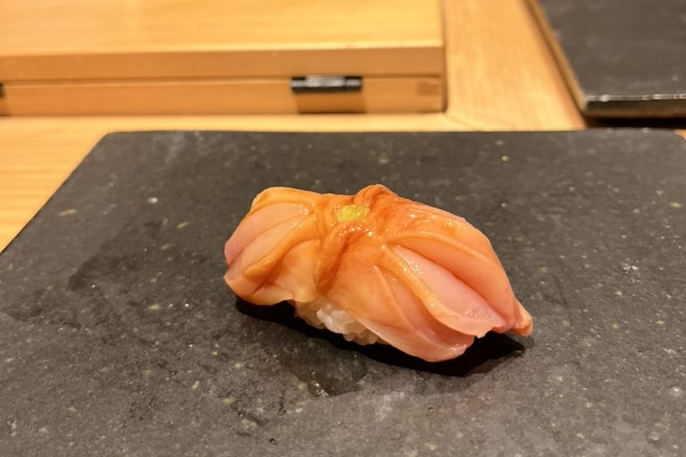 A delicate white fish sliced thin and layered over the rice